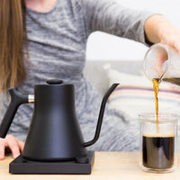 Fellow Stagg EKG Black with girl and beverage being poured