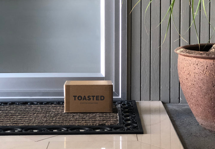 Toasted delivery box on customer doorstep